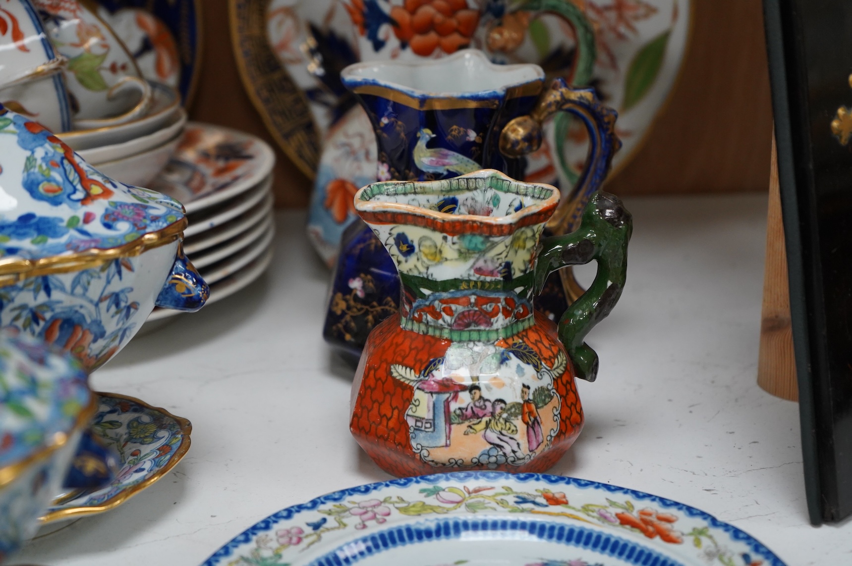 A collection of 19th century English ironstone china to include two pairs of sauce tureens, covers and stands, one marked Masons, various side plates and teacups